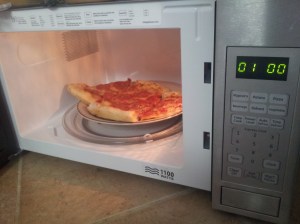 Microwave with pizza inserted